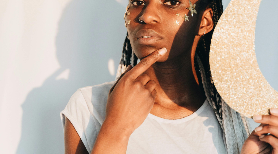 African American woman examining her face