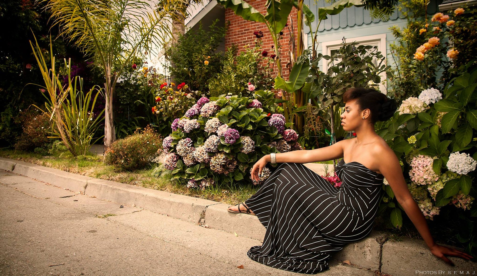 Jasmine in dress modeling on the curb