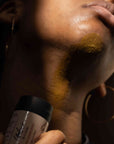 Model applying Shea Shave Stick on neck