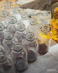 Preparing glass bottles of facial moisturizer products for Umber by J. Lenay clients looking for help with PCOS, ingrown hairs, and acne