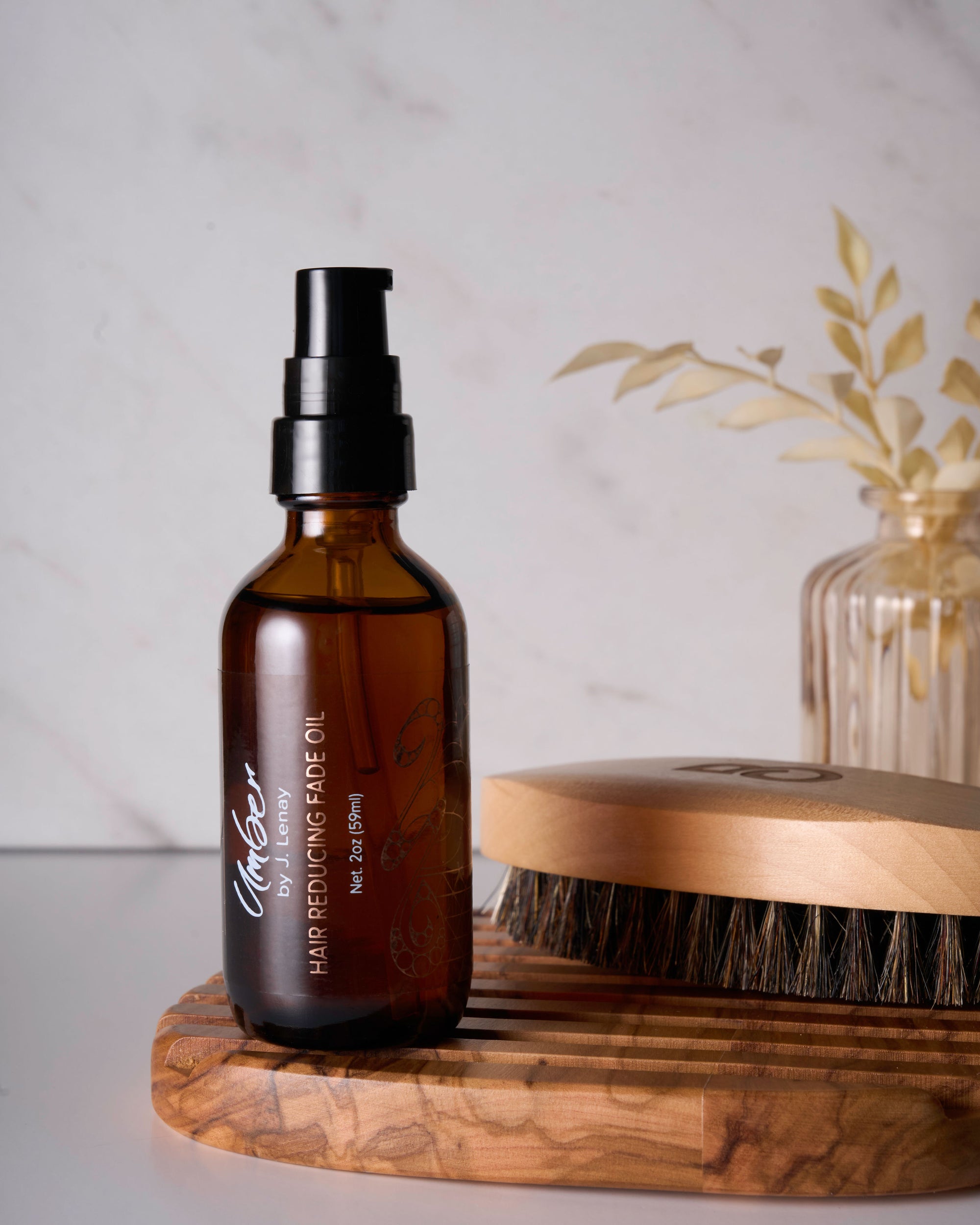Hair Reducing Fade Oil on soap holder with brush next to it