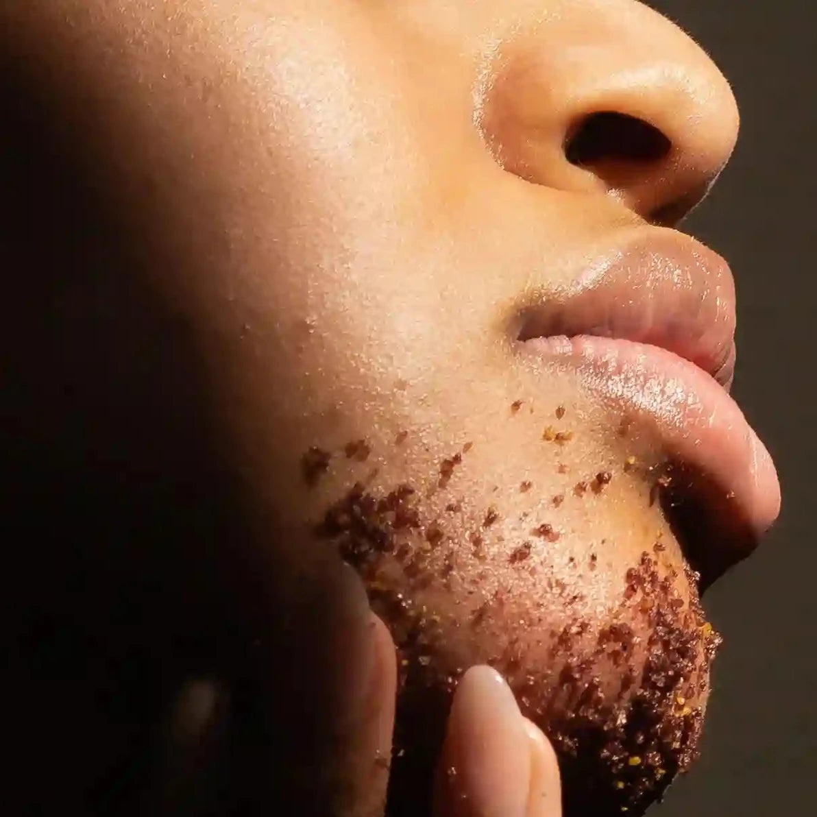 woman applying Homemade Facial Sugar Scrub to her chin